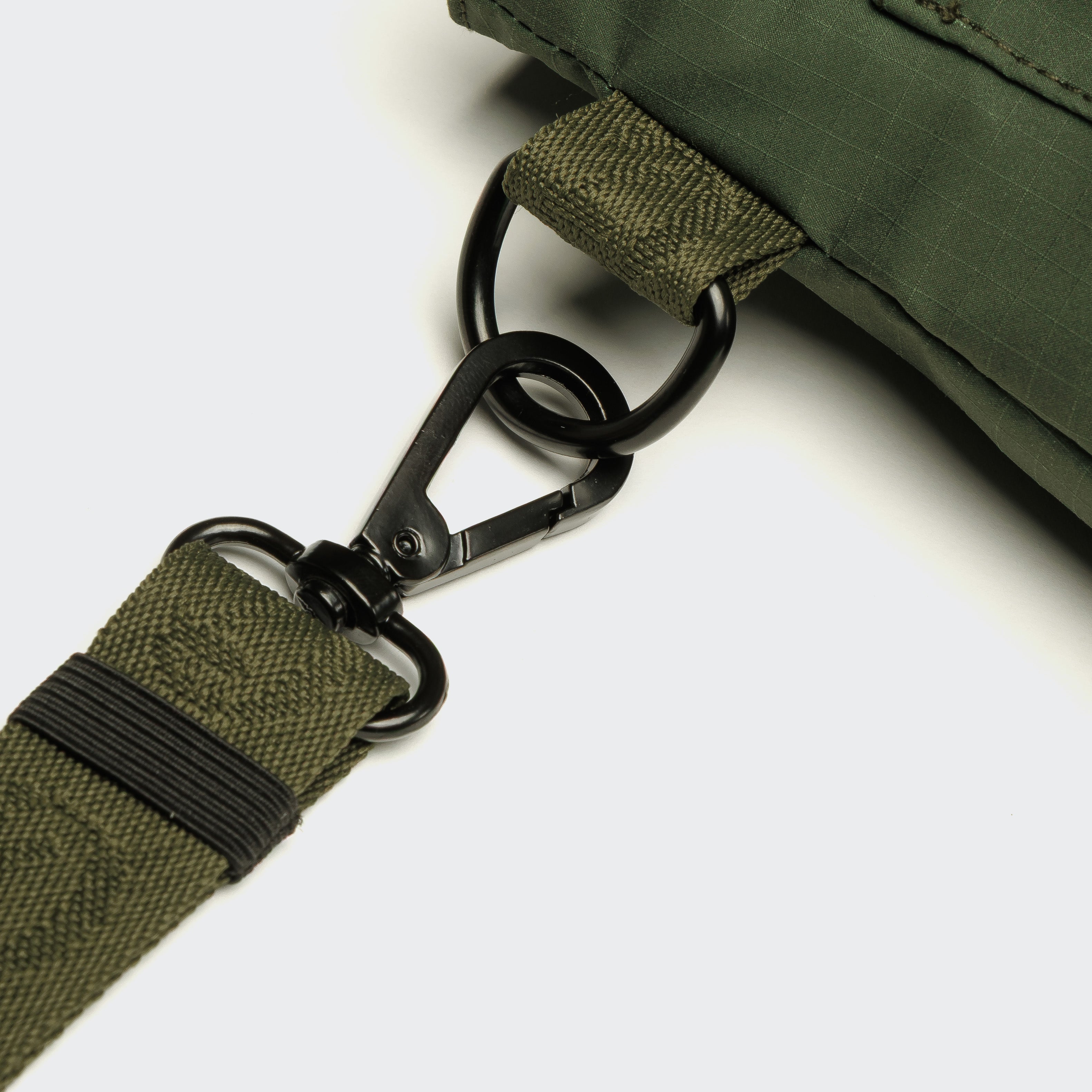 Hands-free olive dog walking bag with adjustable strap worn during outdoor training.