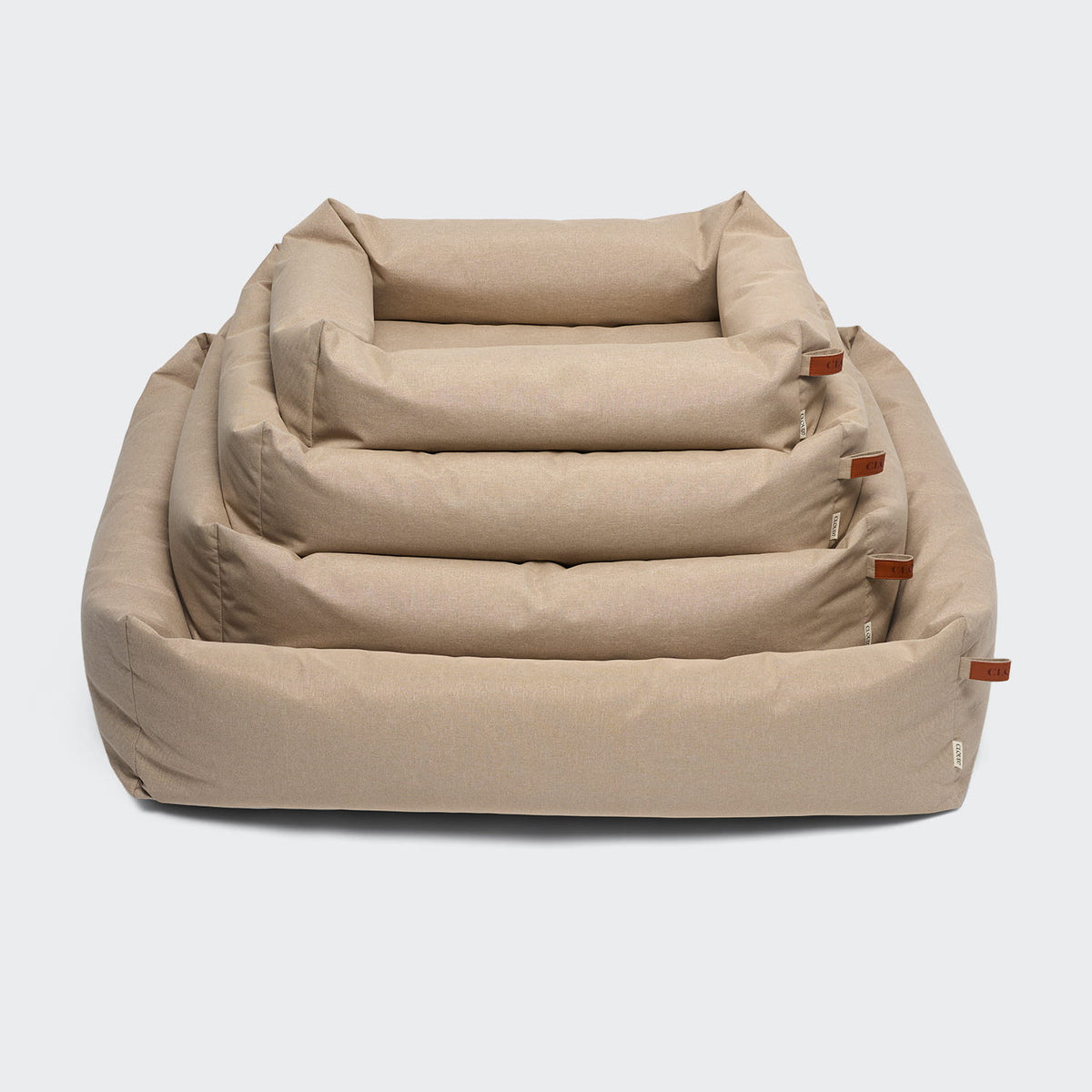 CLOUD7 Sleepy Deluxe indoor and outdoor dog bed with a waterproof cover and protective bolster rim in beige sand.