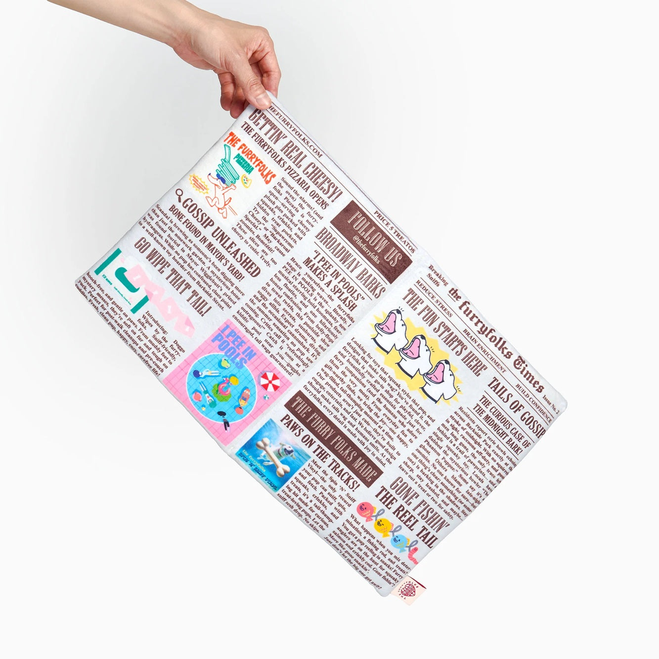Squeaky newspaper-shaped soft toy for dogs, designed for interactive sniffing and treat hunting.