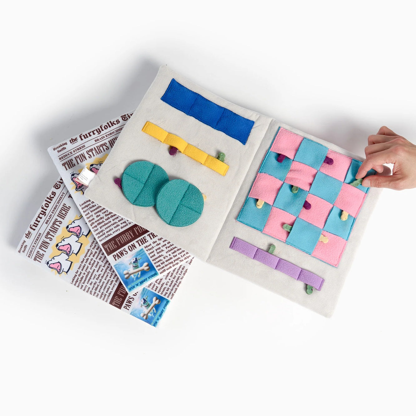 Squeaky newspaper-shaped soft toy for dogs, designed for interactive sniffing and treat hunting.