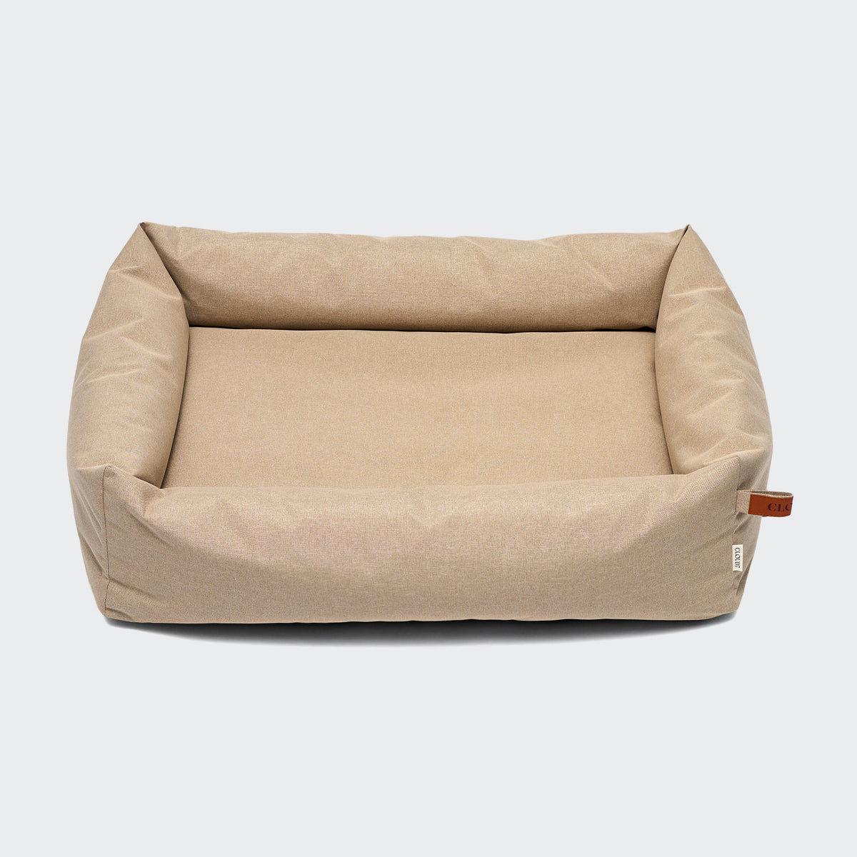 CLOUD7 Sleepy Deluxe indoor and outdoor dog bed with a waterproof cover and protective bolster rim in beige sand.