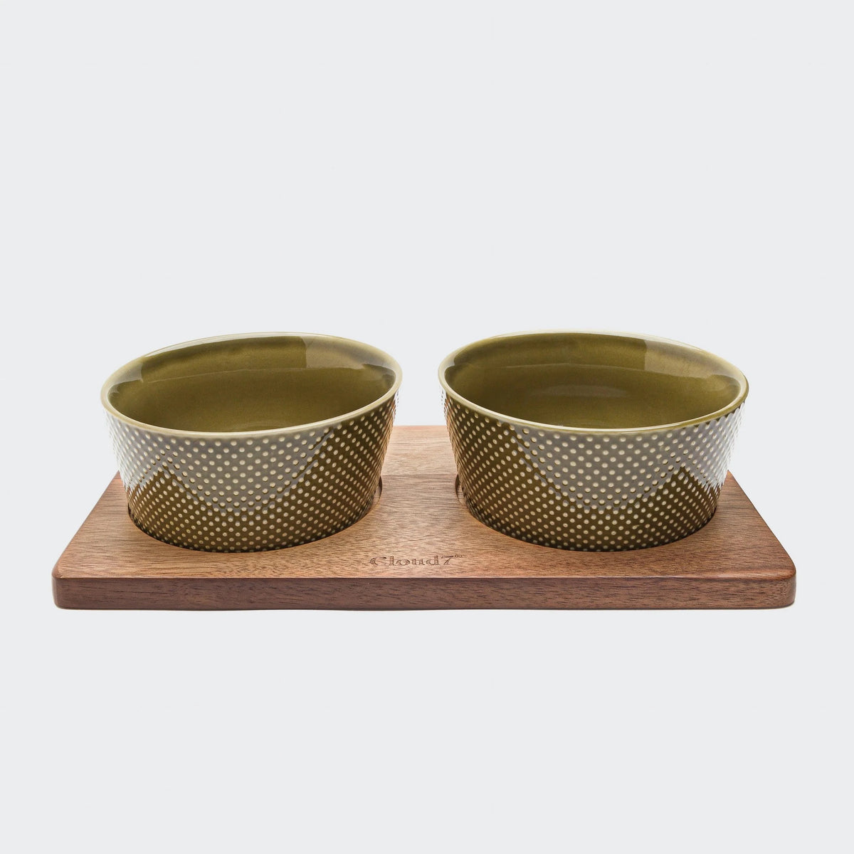 Cloud7 solid acacia wood dog feeding station with non-slip laser-cut perforated bowl slots.
