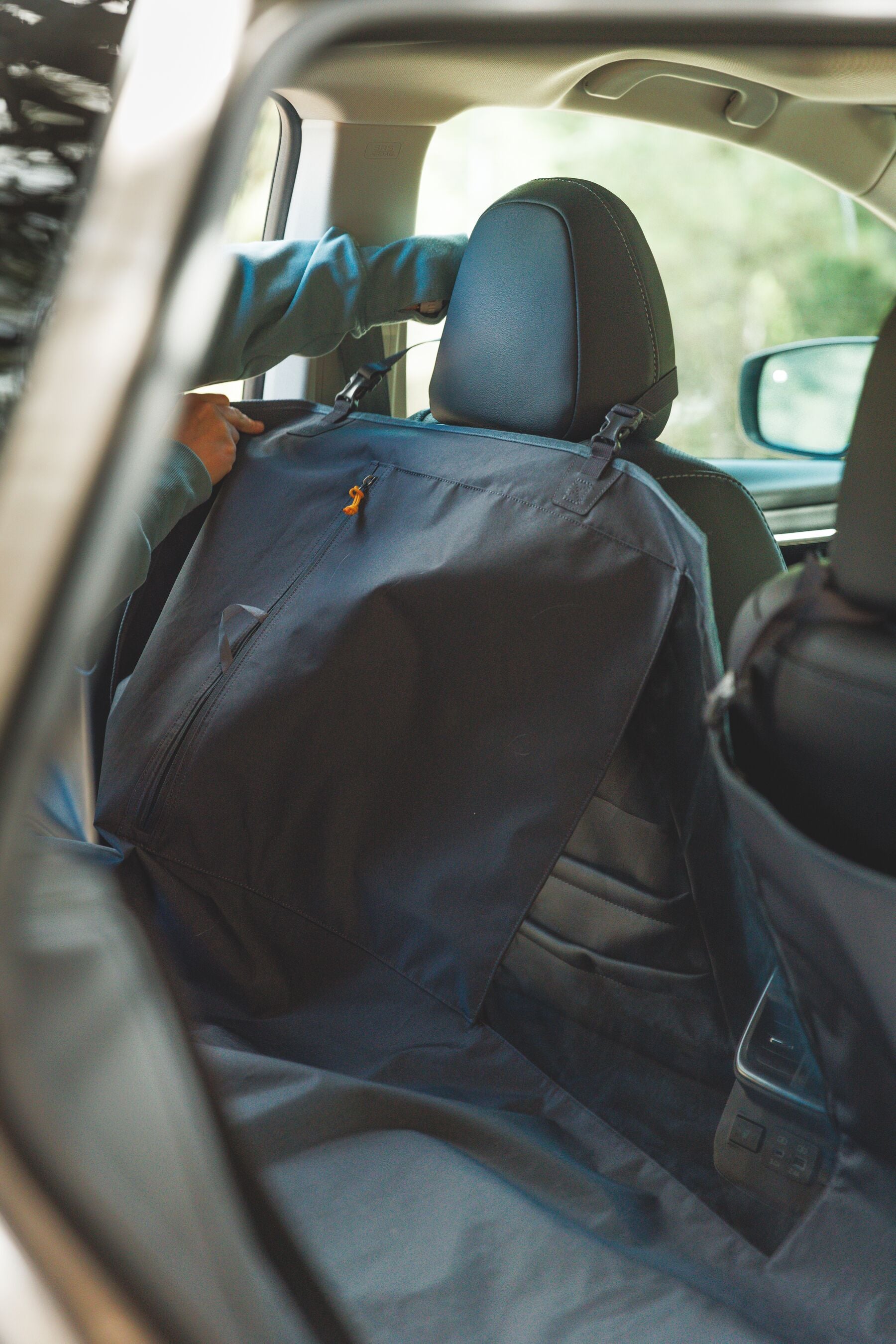 Ruffwear Dirtbag dog car seat cover keeping the backseat safe from wet fur and messy paws